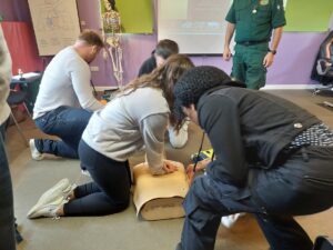 People doing first aid training. In a classroom