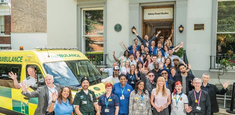 Film and TV production crew with ambulance vehicles for TV filming during film production ambulance hire