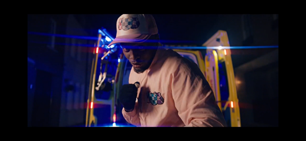 Music video scene filmed with ambulance vehicle and emergency lighting for a dramatic production sequence 